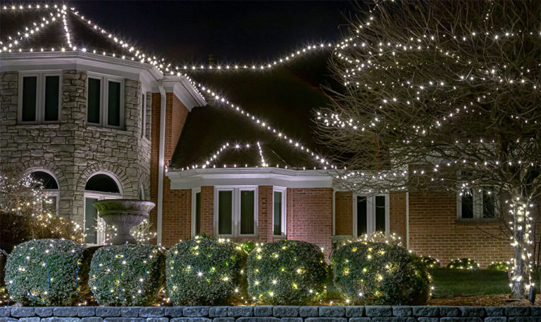 Holiday lighting wrapped around a porch column